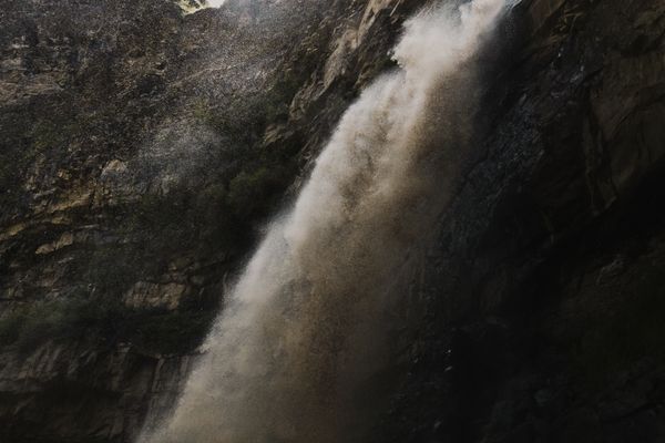 Tall cascading waterfall representing the remote Gura Falls landscape