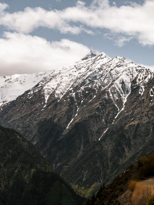 Free Breathtaking view of the snowcapped mountains in Dagestan, Russia, under a cloudy sky. Stock Photo
