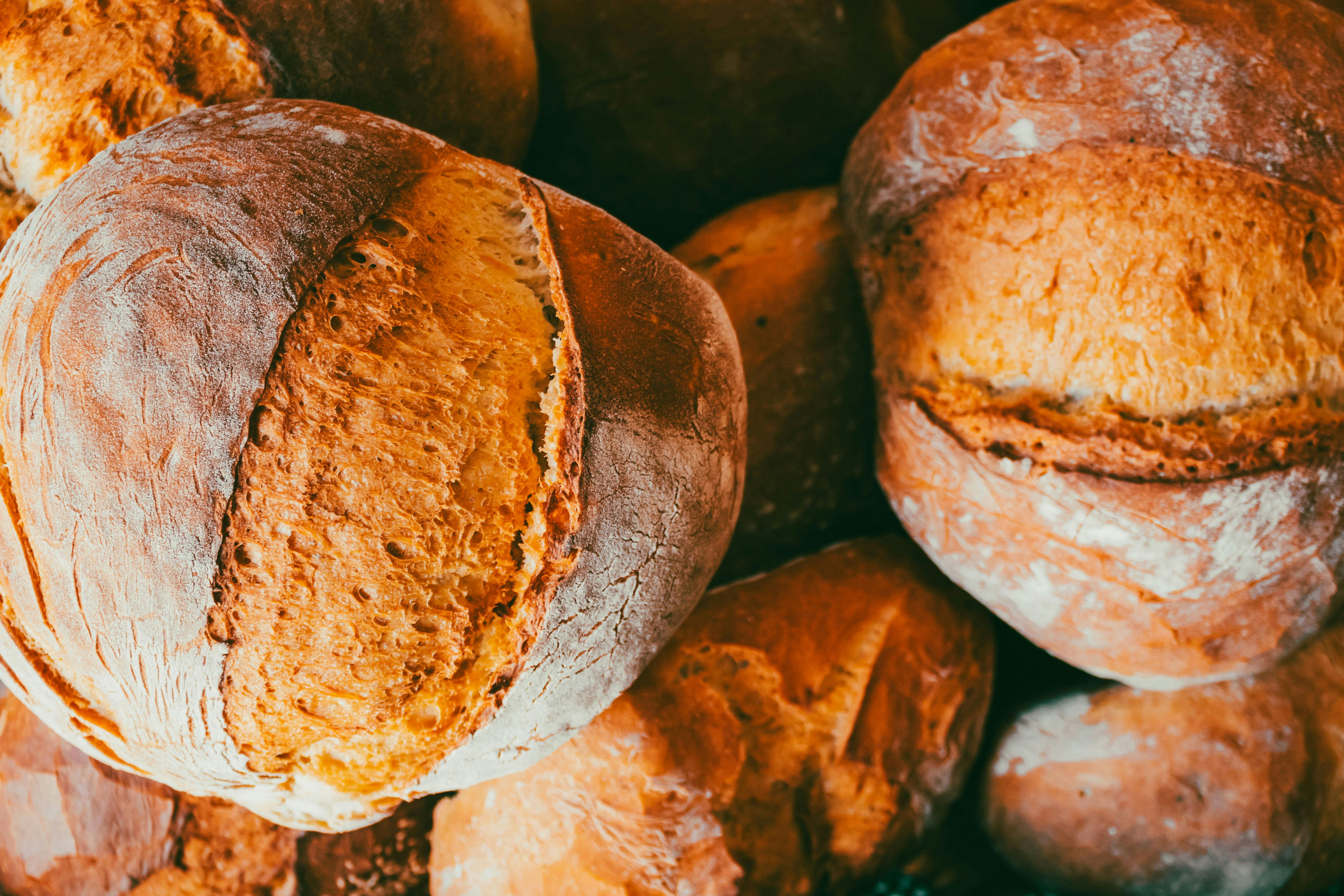 Freshly baked artisan bread with golden crust, perfect for bakeries and culinary websites.