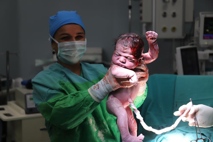 Doctor Holding Newborn