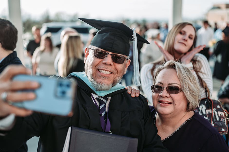Ennaltaehkäisy ja arjen toimet Ennaltaehkäisy ja arjen toimet - A graduate in cap and gown takes a cheerful selfie with family, celebrating their achievemen