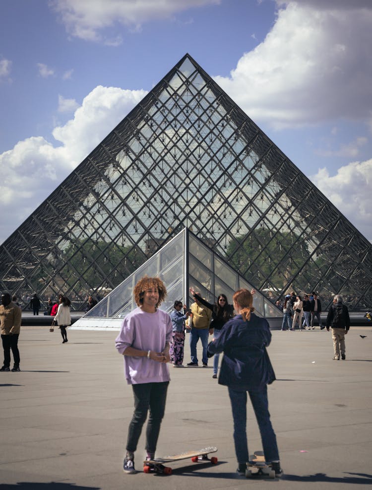 People With A Skateboard Standing In Front Of A Museum 