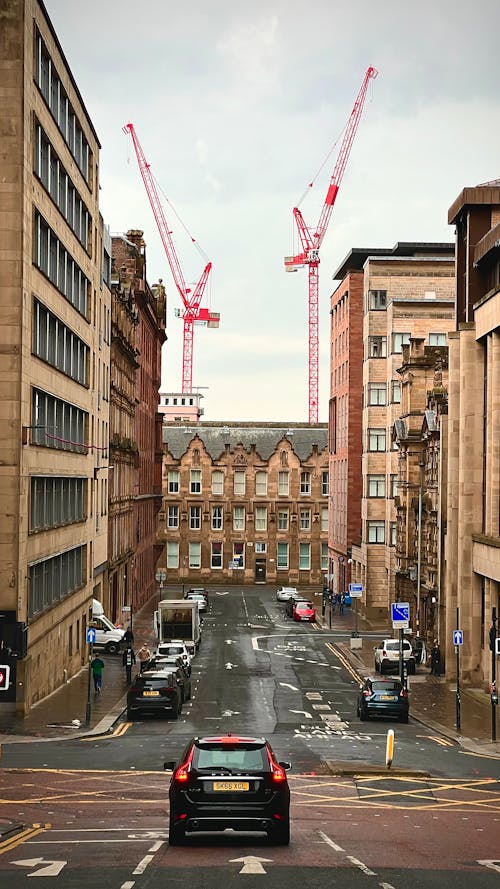 Tower Cranes Behind City Buildings