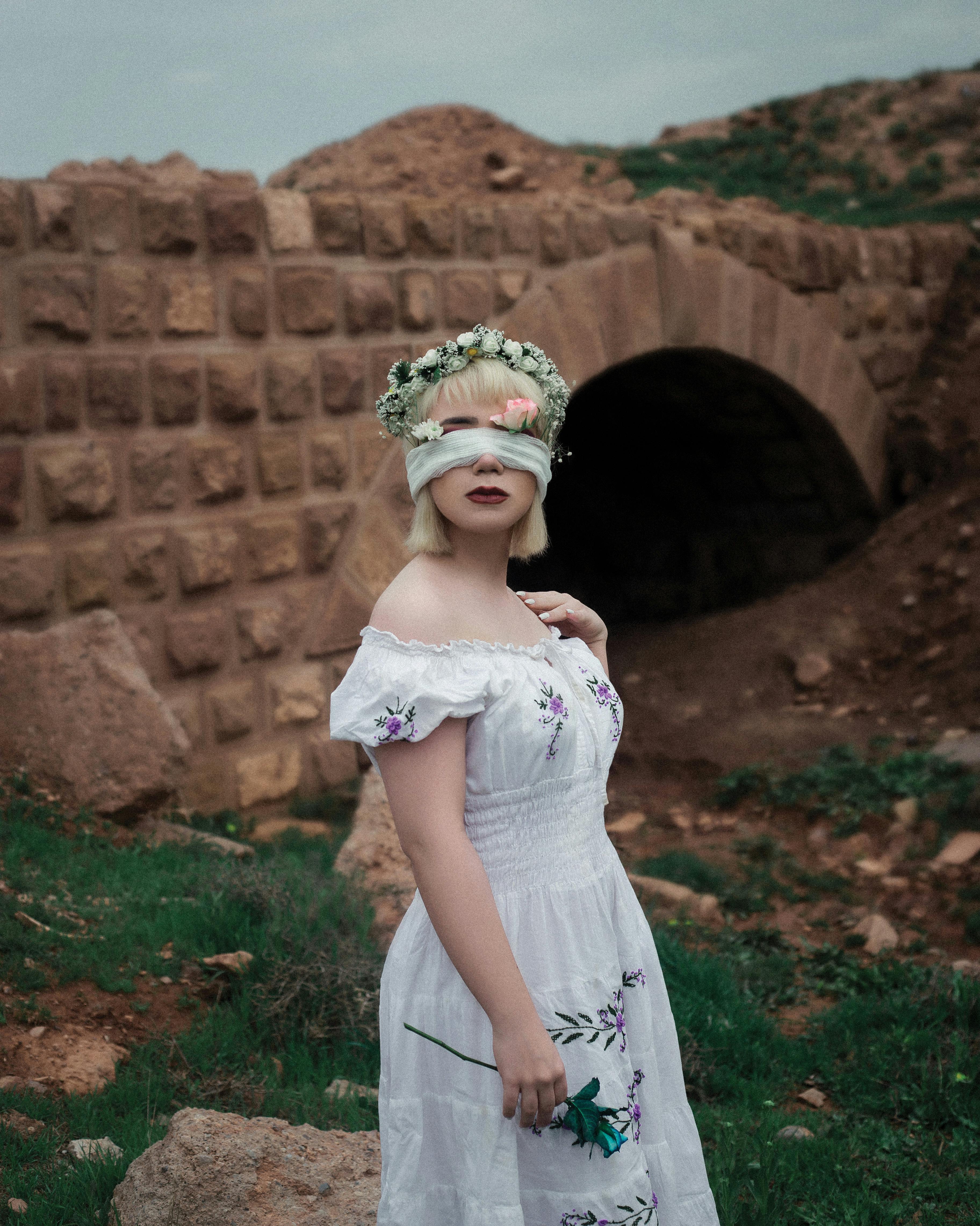 portrait of beautiful woman wearing dress and blindfolded