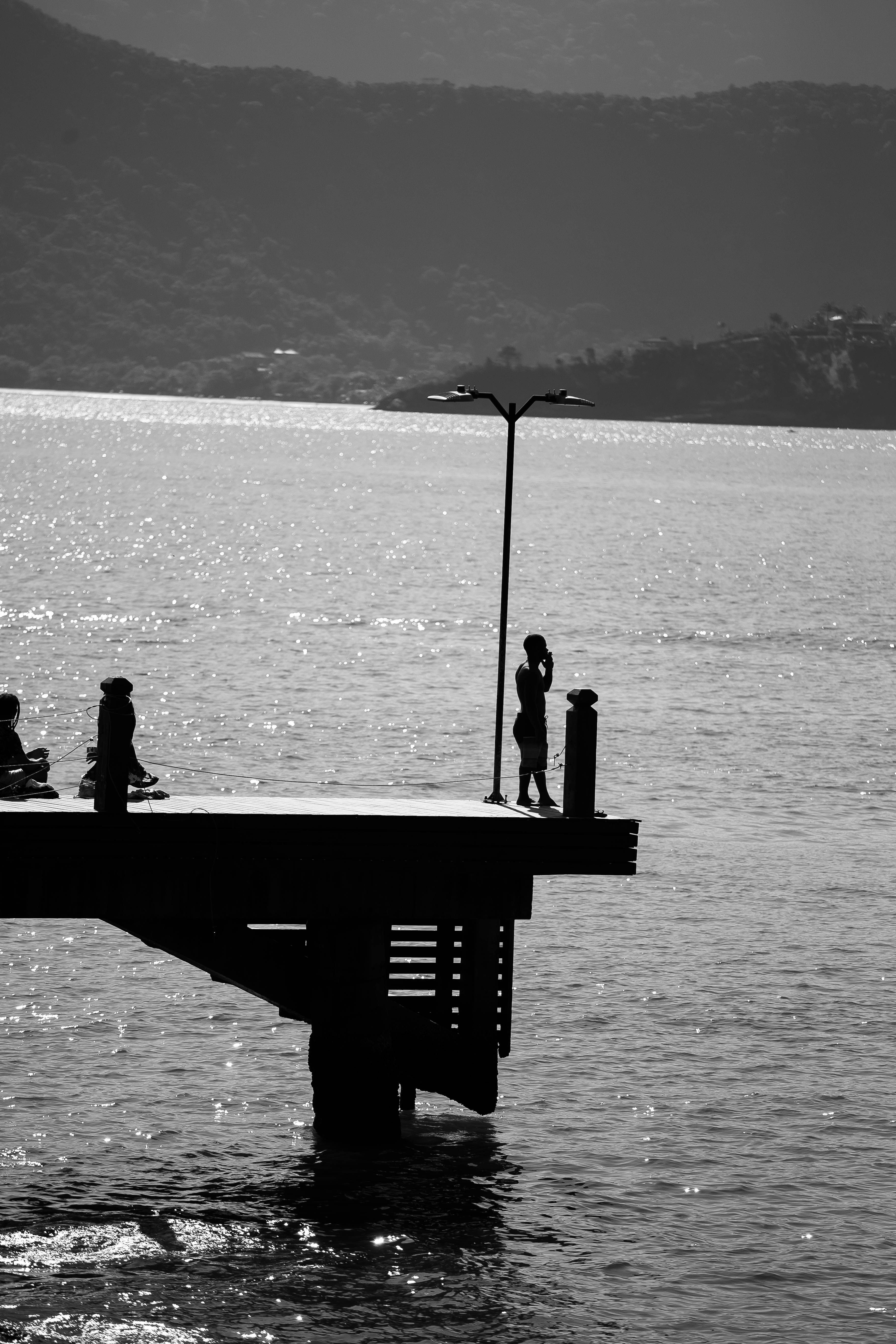 Silhouette of Person Standing on the Dock · Free Stock Photo