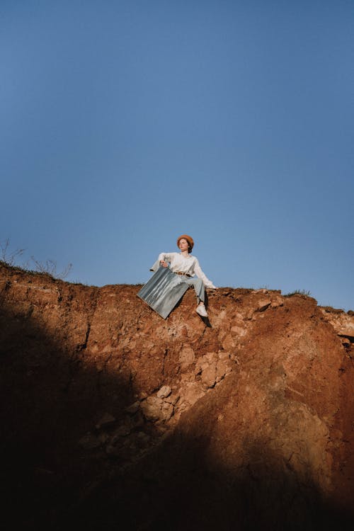 Woman Sitting on Rocks