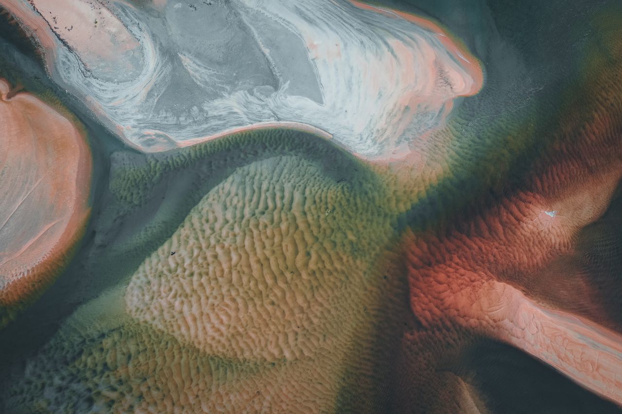 stunning aerial shot of colorful sand patterns resembling abstract art