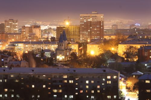 Free A striking aerial view of a city at night, showcasing brightly lit buildings and urban landscape. Stock Photo