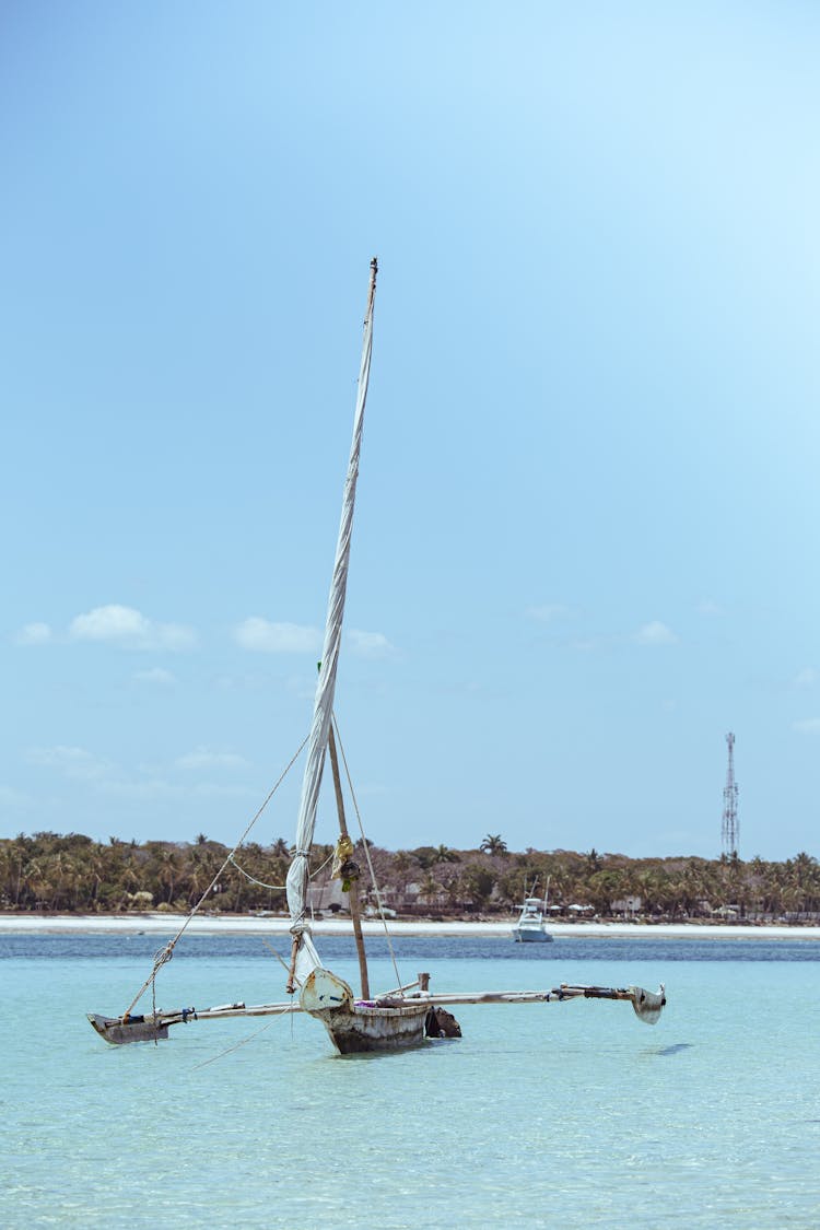 Wooden Sailboat Anchored On Sea