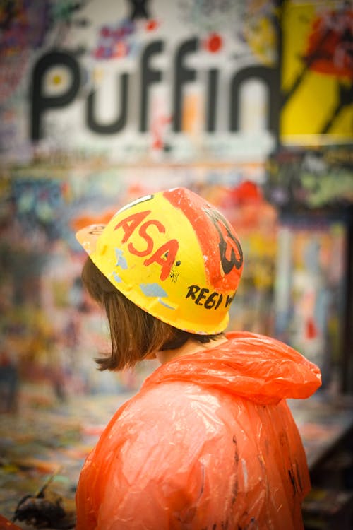 Woman in Yellow Hard Hat and Orange Raincoat 