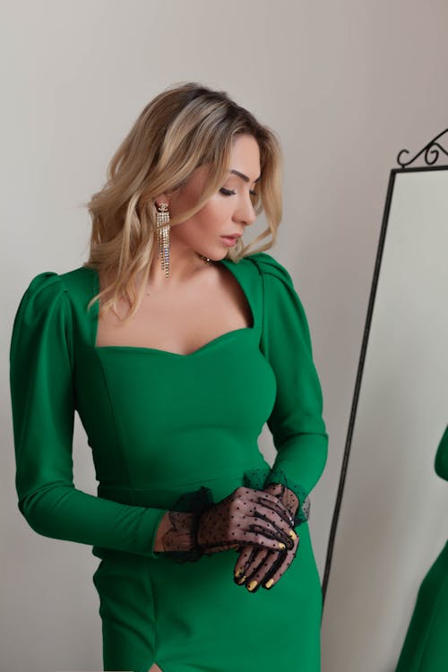 Woman Wearing a Green Dress Looking Down