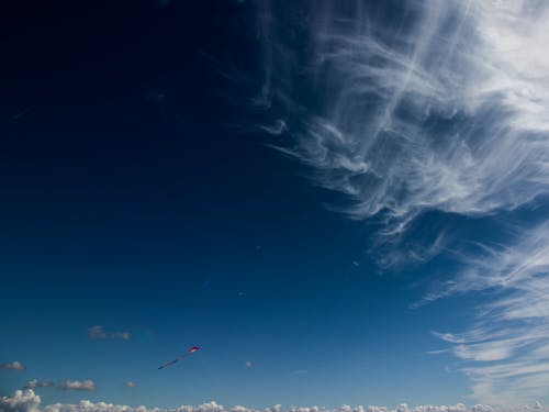 Kite Flying on White Clouds and Blue Sky