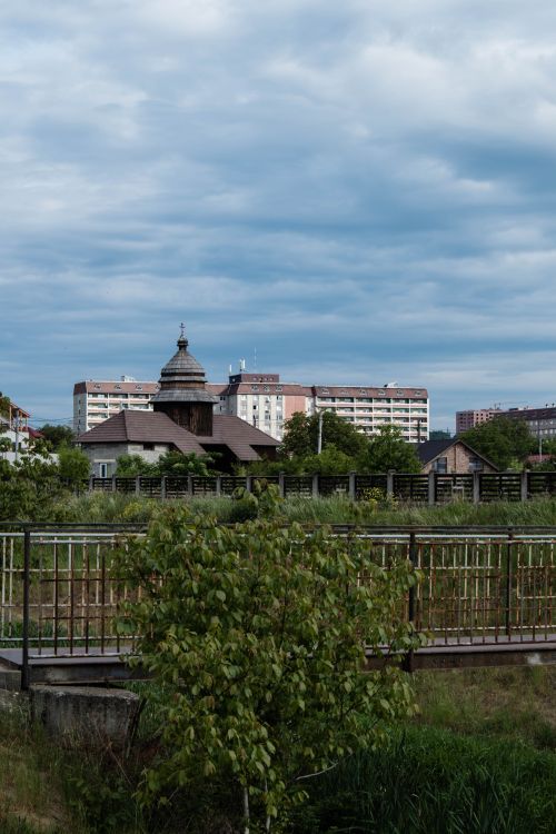 Free Skyline showcasing residential buildings, historic church, and greenery under a cloudy sky. Stock Photo