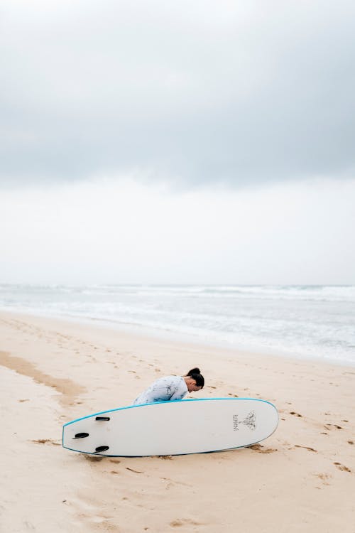 Woman on Beach with Surfing Board