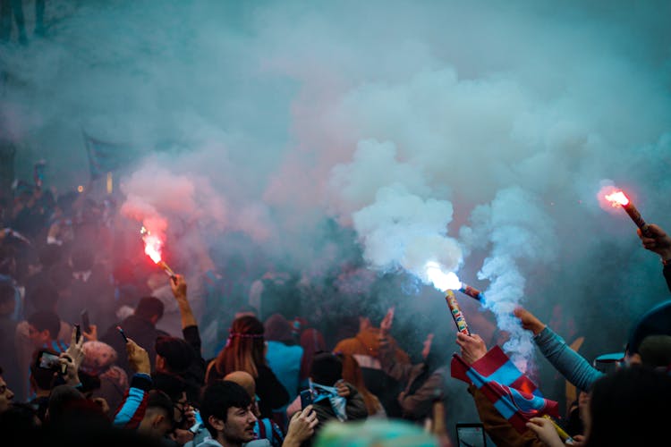 People Holding Flares