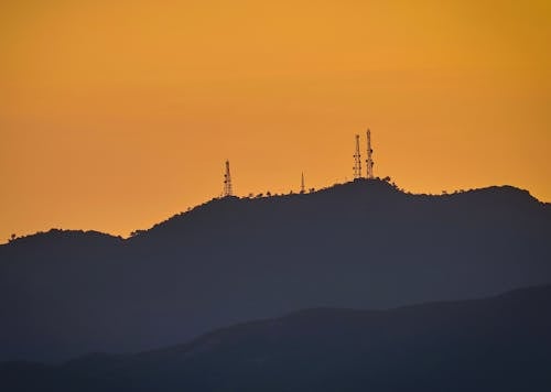 Silhouette of Mountain with Metal Towers