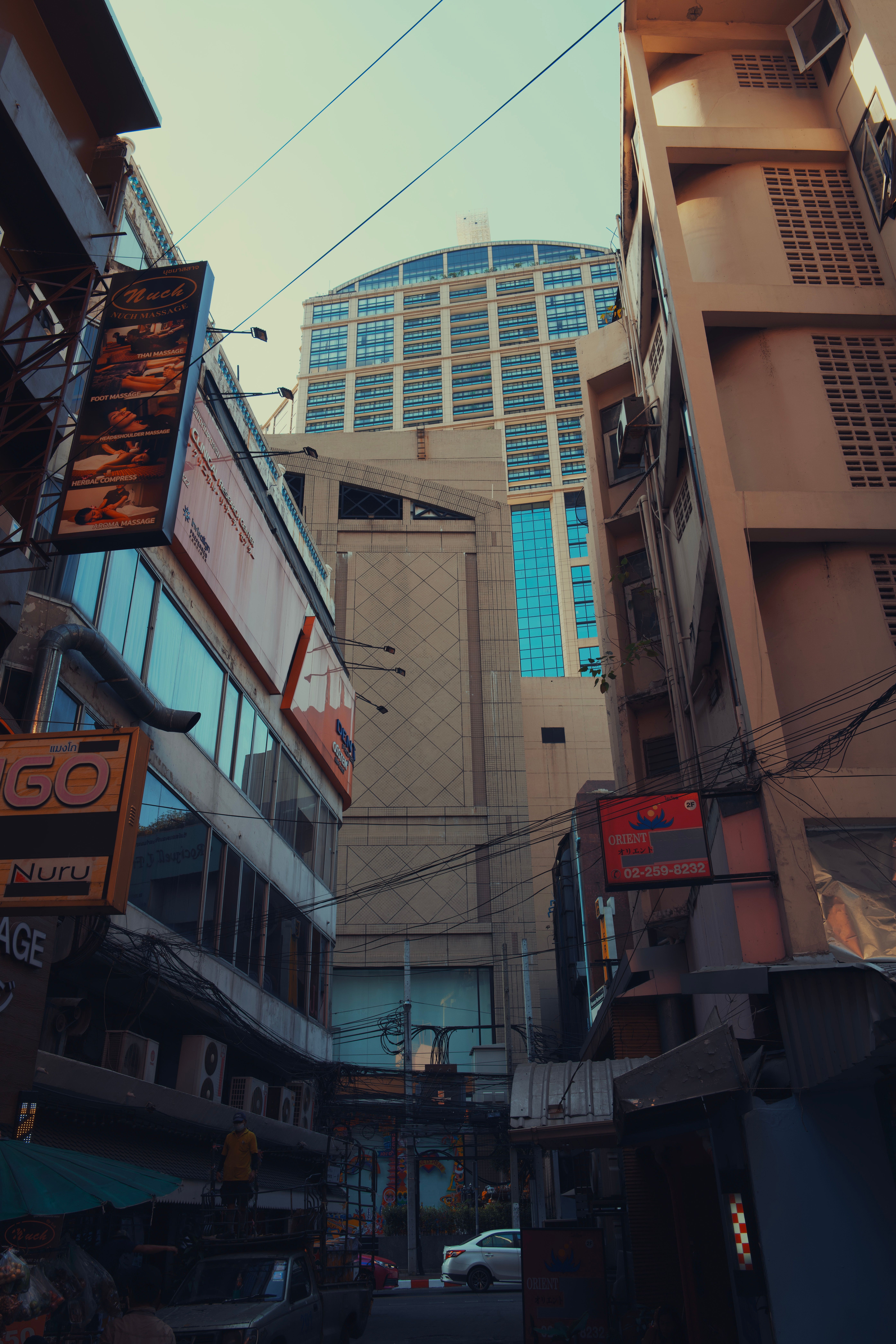 Vertical view of Bangkok's urban architecture with high-rise buildings surrounded by local street shops.