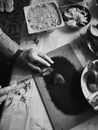 Grayscale Photo of Person Holding Round Fruit