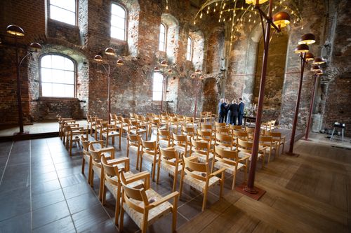 Free Elegant church interior with arranged chairs and vintage lamps for an event. Stock Photo