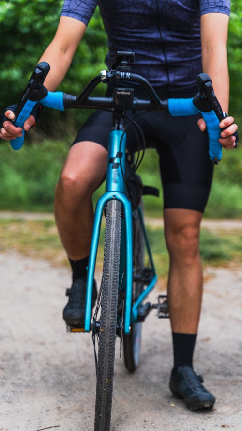 Photo of a Person Riding a Blue Bike