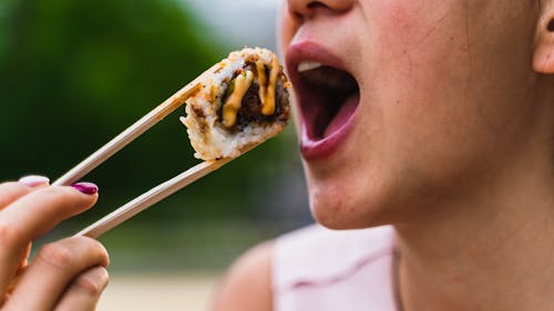 A Person Eating a Sushi