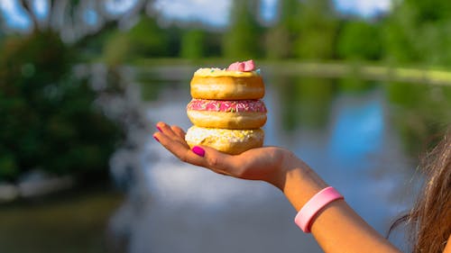 Person Holding Donuts