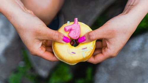 Overhead Shot of a Person's Hands Holding a Donut