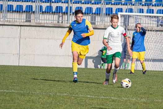 Young soccer players competing in a match on a sunny day in Slovakia.