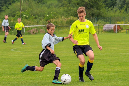 Boys playing soccer on a sunny day at a local tournament in Strečno, Slovakia.