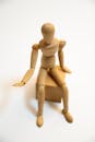 Brown Wooden Human Figurine on White Surface