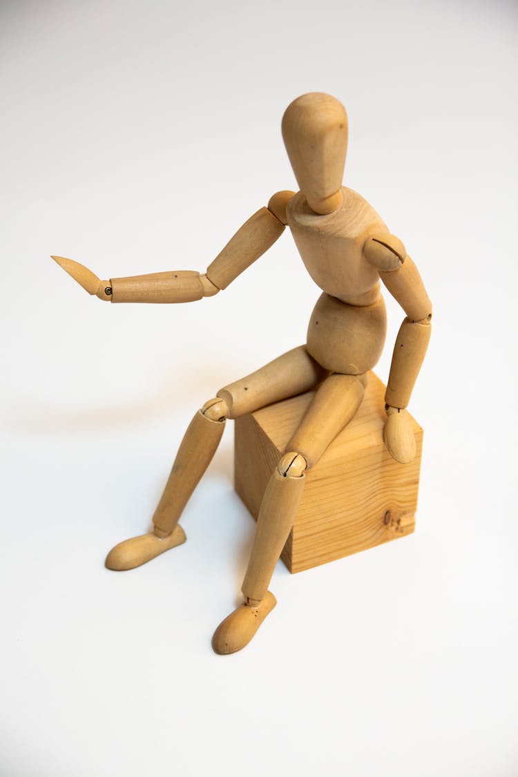 Brown Wooden Human Figure On Brown Wooden Block