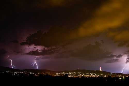 Free Vivid lightning strikes during a storm over Pécs, Hungary, illuminating the city at night. Stock Photo