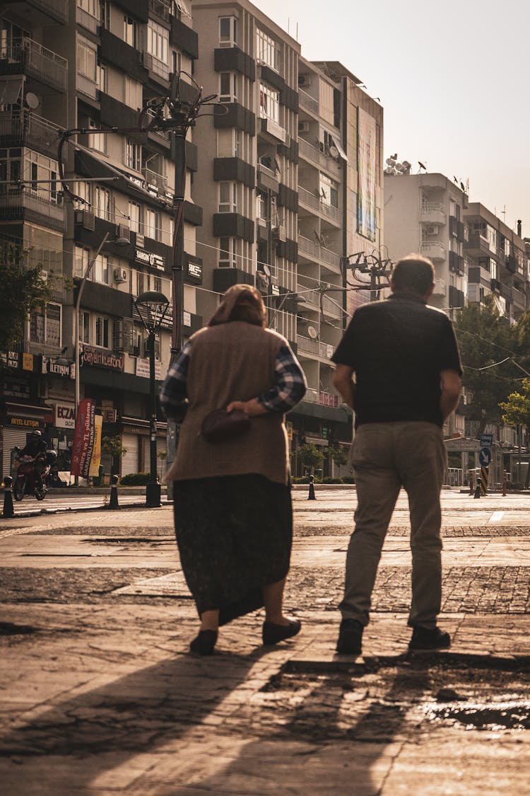 Elderly Couple Waking On Concrete Pavement