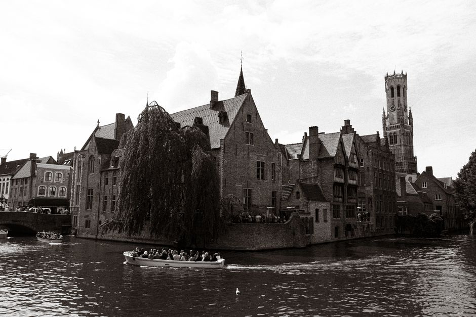 A scenic canal boat tour in Bruges, Belgium, passing historic buildings