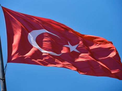 Turkish flag waving in the blue sky