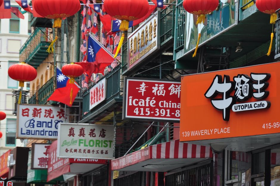 Vibrant storefronts and lanterns in San Francisco's iconic Chinatown street.