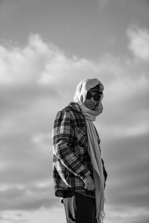 Free A Low Angle Shot of a Man in Plaid Long Sleeves Wearing Headscarf Stock Photo