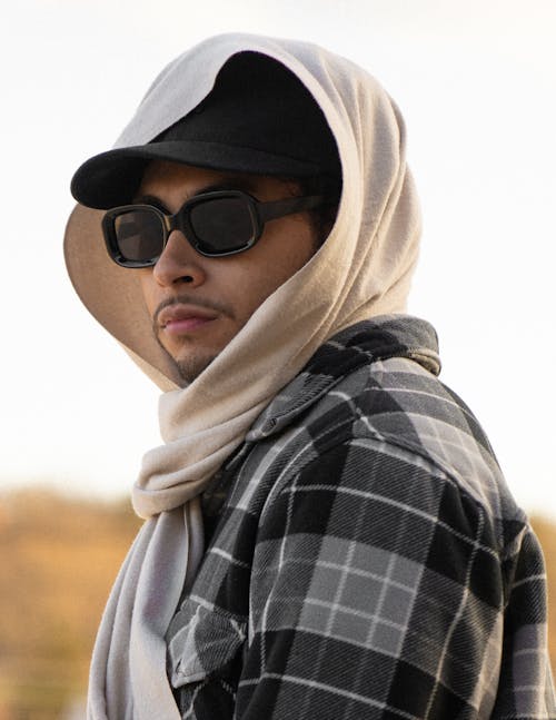 Portrait of a Young Man Wearing Sunglasses, a Baseball Cap and a Headscarf