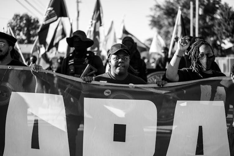 Protestors Holding A Banner