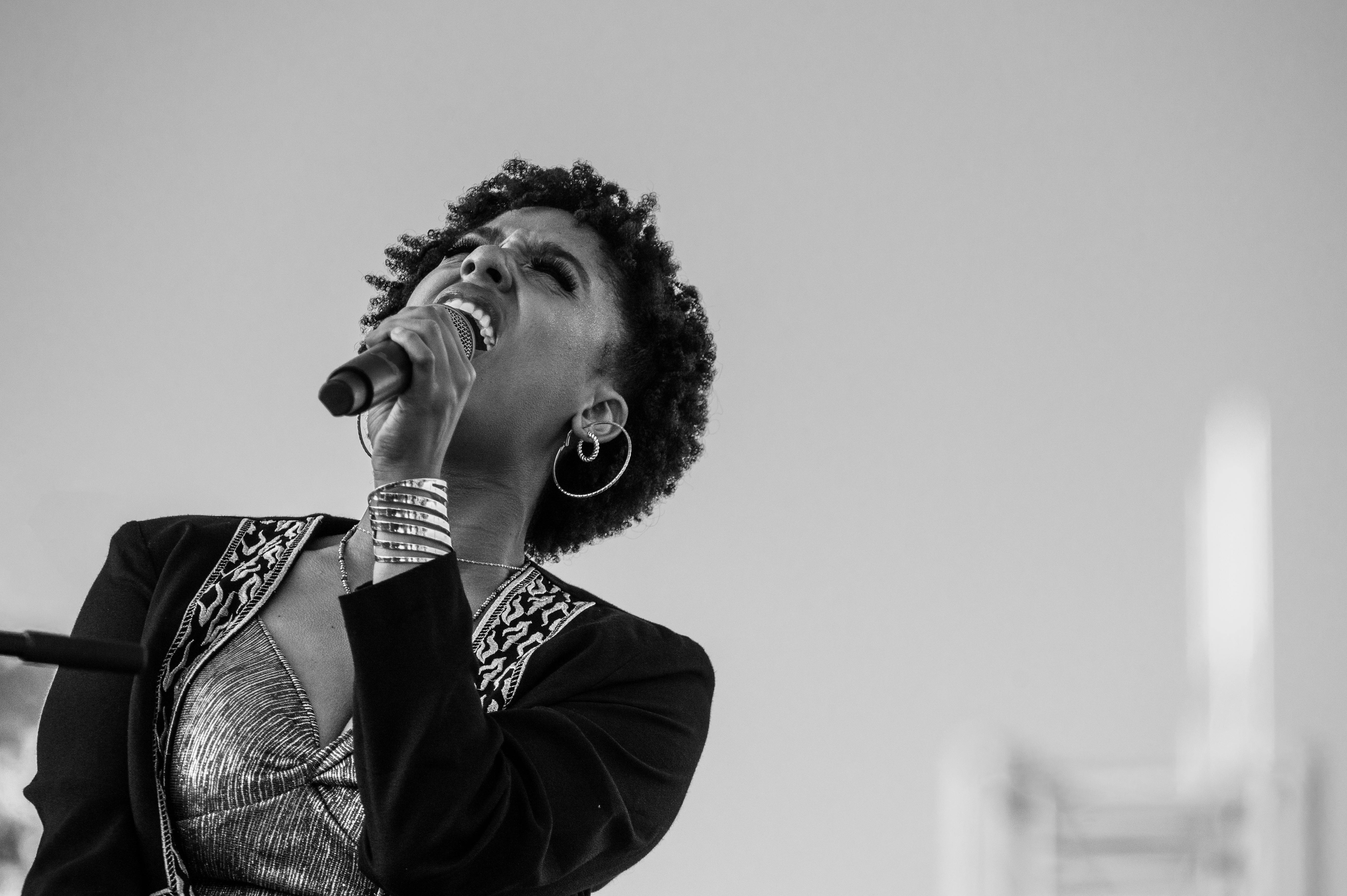 Grayscale Photo of a Woman Singing · Free Stock Photo