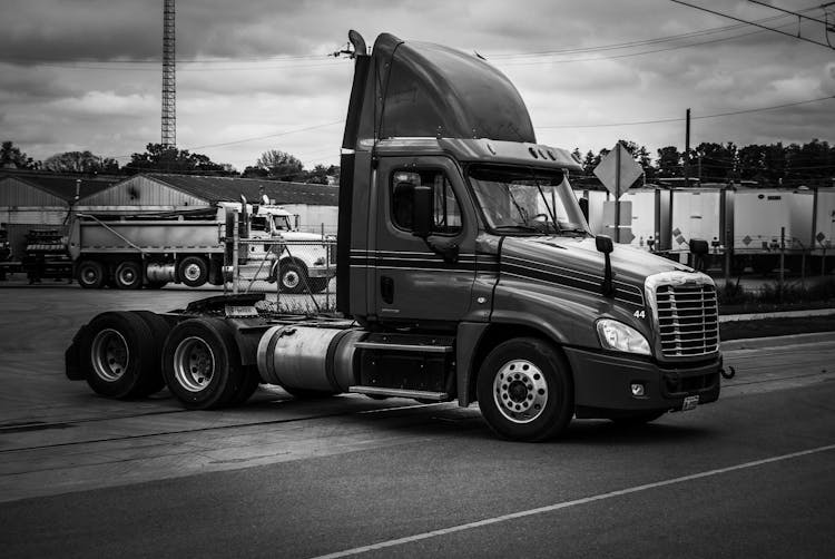 Grayscale Photo Of Semi Trailer Truck On The Road