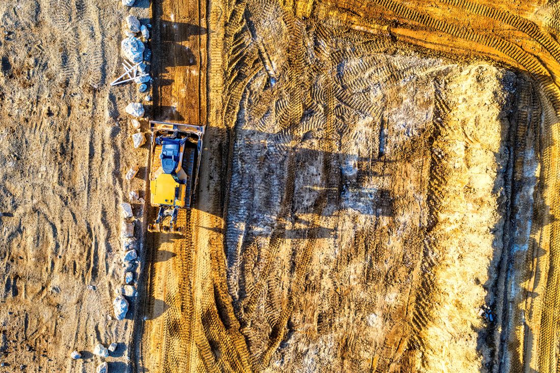 Aerial view of a bulldozer working a large dirt site