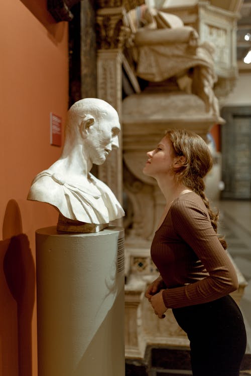 Young Woman Standing in front of a Sculpture inside the Pushkin State Museum of Fine Arts in Moscow, Russia