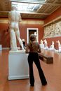 Woman in Black Pants Standing Beside White Statue