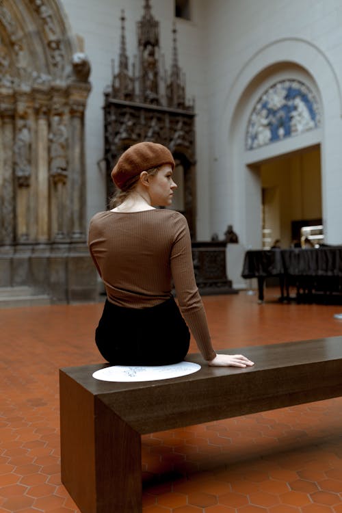 Young Woman Sitting on a Bench inside the Pushkin State Museum of Fine Arts in Moscow, Russia