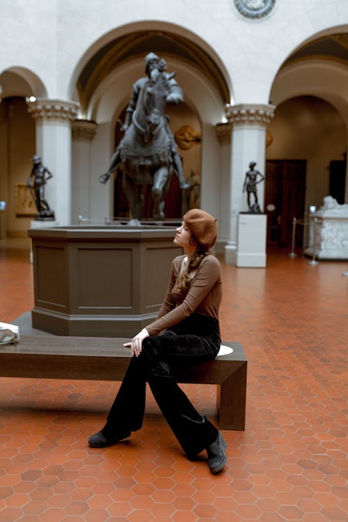 Young Woman Sitting on a Bench inside the Pushkin State Museum of Fine Arts in Moscow, Russia