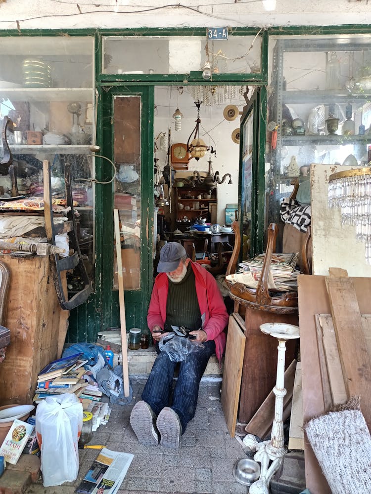 A Man Sitting In A Warehouse