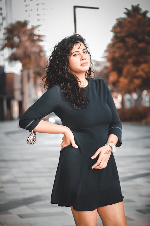 Portrait of a Young Woman Posing in a Black Dress