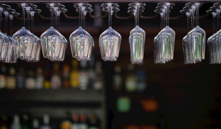 Drinking Glasses Hanging From A Bar Rack