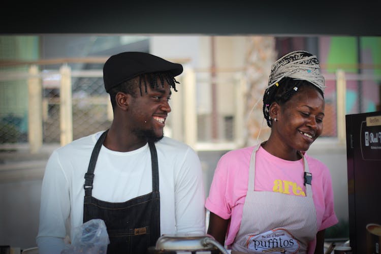 Young Man And Woman Working Together In A Street Food Restaurant 